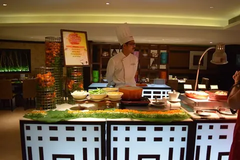Chef at a live cooking counter in a buffet set-up